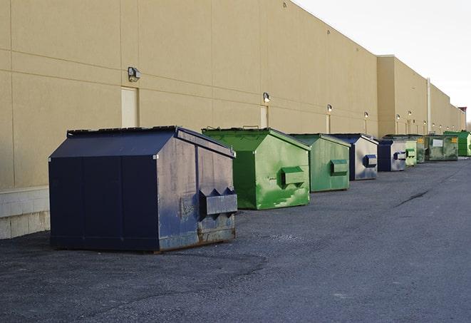 large construction waste containers in a row at a job site in Buena